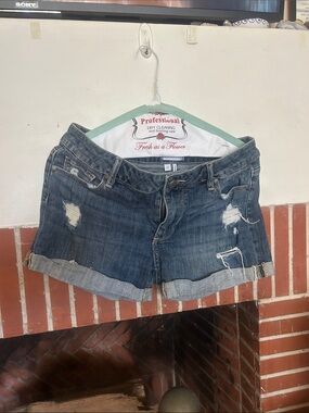PAIGE Distressed Dark Blue Rolled Cuff Denim Shorts